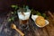 Affogato, a scoop of vanillaÂ ice cream in a glass of espresso served with peanut cookies in dark background